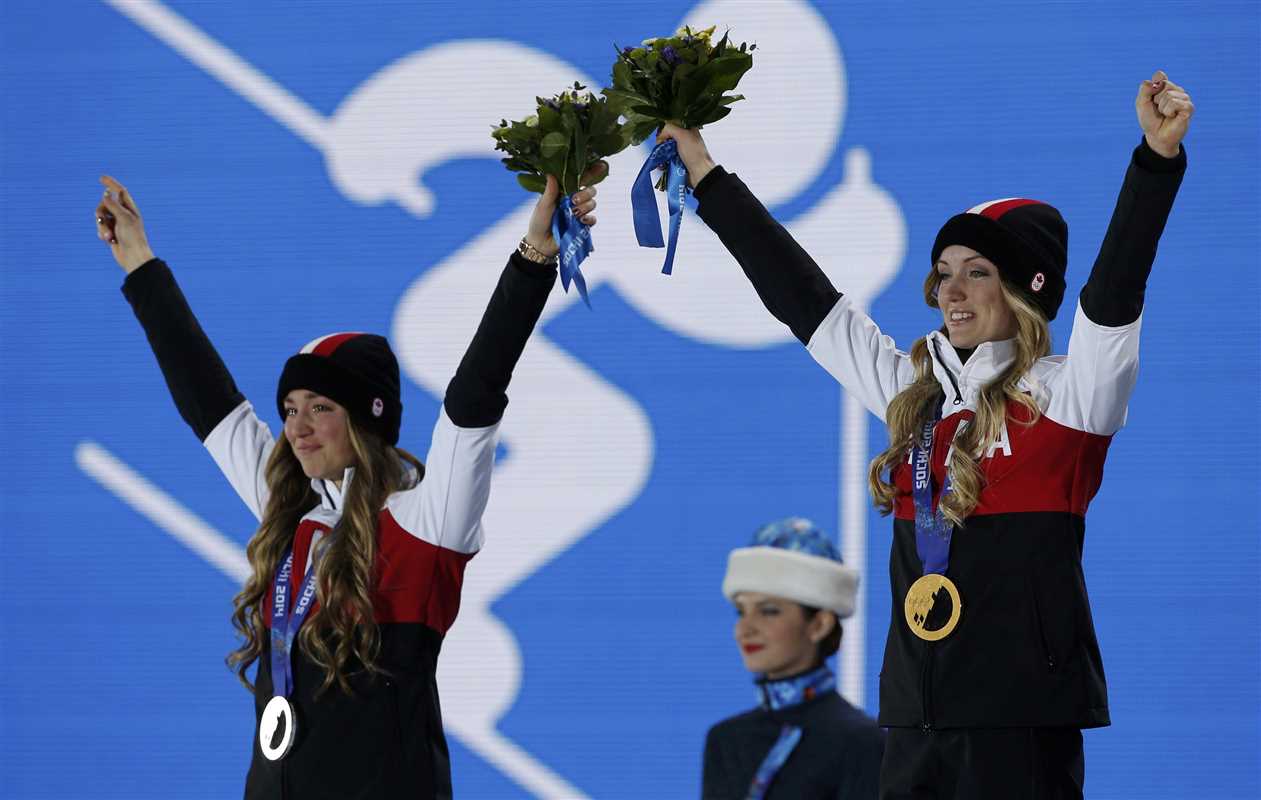 Gold medalist Justine Dufour-Lapointe of Canada and her compatriot, silver medalist Dufour-Lapointe, pose during the medal ceremony for the women's freestyle skiing moguls at the Sochi 2014 Sochi Winter Olympics