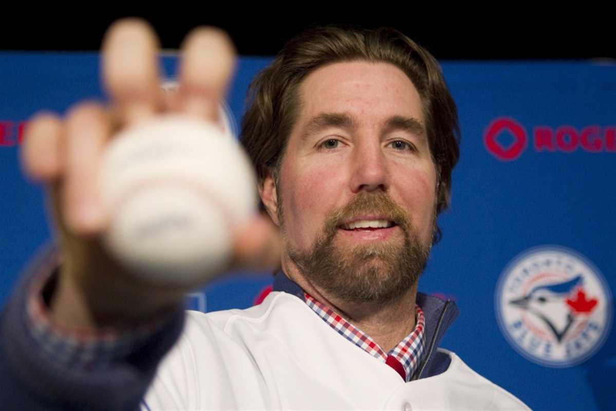 Pitcher R.A. Dickey demonstrates his knuckleball grip following a news conference in Toronto on Tuesday January 8, 2013 as the Toronto Blue Jays introduce the newest addition to their roster. THE CANADIAN PRESS/Chris Young
