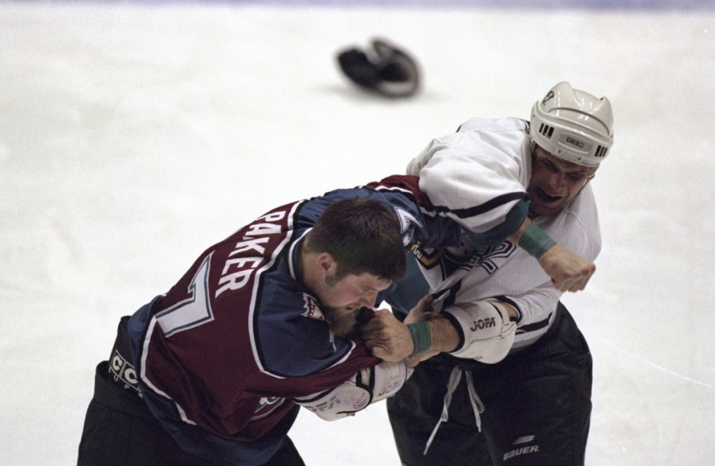 21 Dec 1998: Stu Grimson #32 of the Anaheim Mighty Ducks hits Scotts Parker #27 of the Colorado Avalanche at Arrowhead Pond in Anaheim, California. The Avalanche defeated the Ducks 4-2.