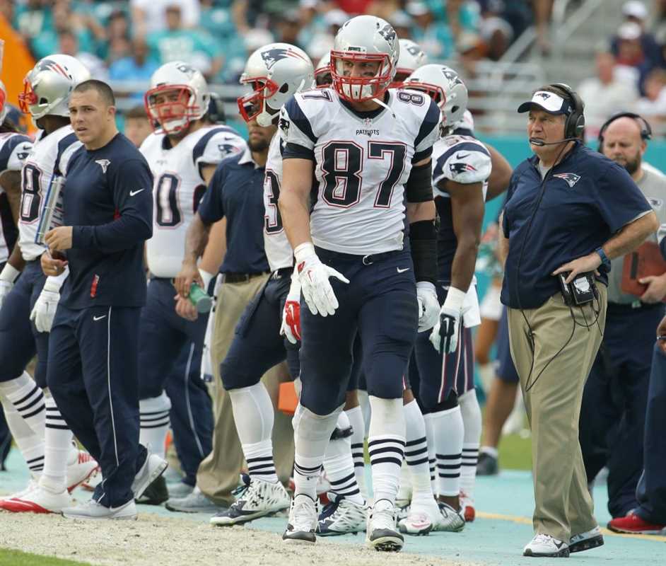 New England Patriots tight end Rob Gronkowski (87) and head coach Bill Belichick, right, walk the sidelines during the second half of an NFL football game, Sunday, Jan. 3, 2016, in Miami Gardens, Fla. The Dolphins defeated the Patriots 20-10. (AP Photo/Lynne Sladky) ORG XMIT: SLS123